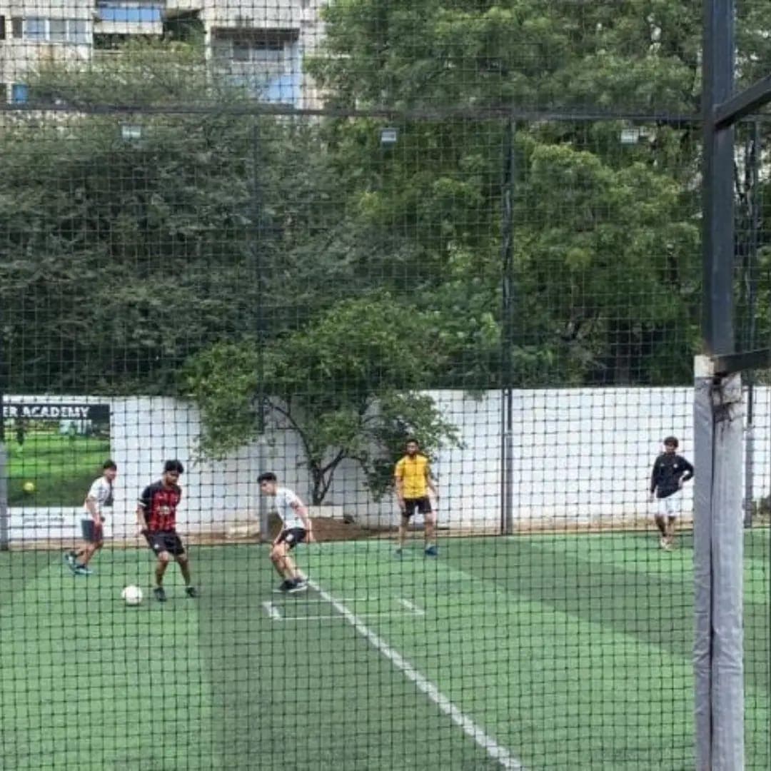 FCC students playing football on a turf ground